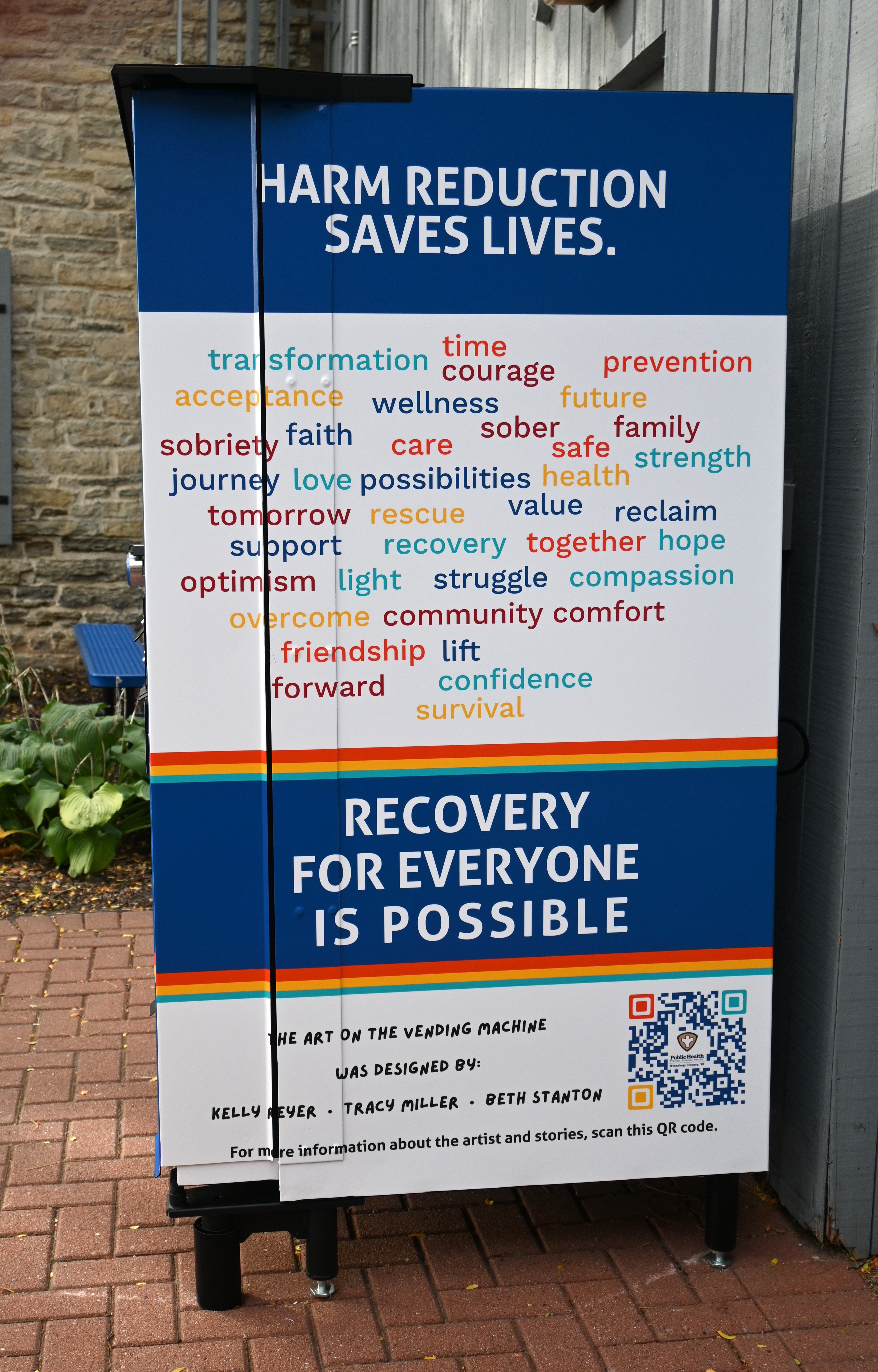 Photo of the right side of the vending machine featuring a word cloud and the words "Recovery for everyone is possible".